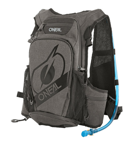 A close-up of the ONEAL O'NEAL Romer Hydration Backpack reveals a hydration bladder partially visible through an open zipper compartment. The blue hydration pack with a black cap is ideal for outdoor activities, boasting padded straps, mesh pockets, and adjustable chest and waist straps.