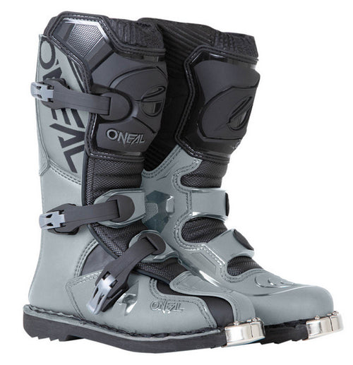 A pair of O'Neal Youth ELEMENT Boot - Grey is shown. The boots feature a durable Goodyear welt sole, sturdy buckles, reinforced toes with metal guards, and branding with the text "ONEAL" on the side. The design emphasizes protection and durability for off-road motorcycling.