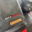 A pair of black Oilskin Fur Lined ATV Mitts by STYX MILL, designed for scooters or bicycles, with inner fur lining. One mitt displays the "CITYHORN" label in red and white text, shown on a white background.
