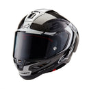 The ALPINESTARS Supertech R10 Helmet Element flaunts a sleek carbon and silver design with advanced aerodynamics. It features a glossy finish, angular patterns, a large tinted visor, and showcases a prominent logo on the front with subtle side text.