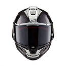 The ALPINESTARS Supertech R10 Helmet Element flaunts a sleek carbon and silver design with advanced aerodynamics. It features a glossy finish, angular patterns, a large tinted visor, and showcases a prominent logo on the front with subtle side text.