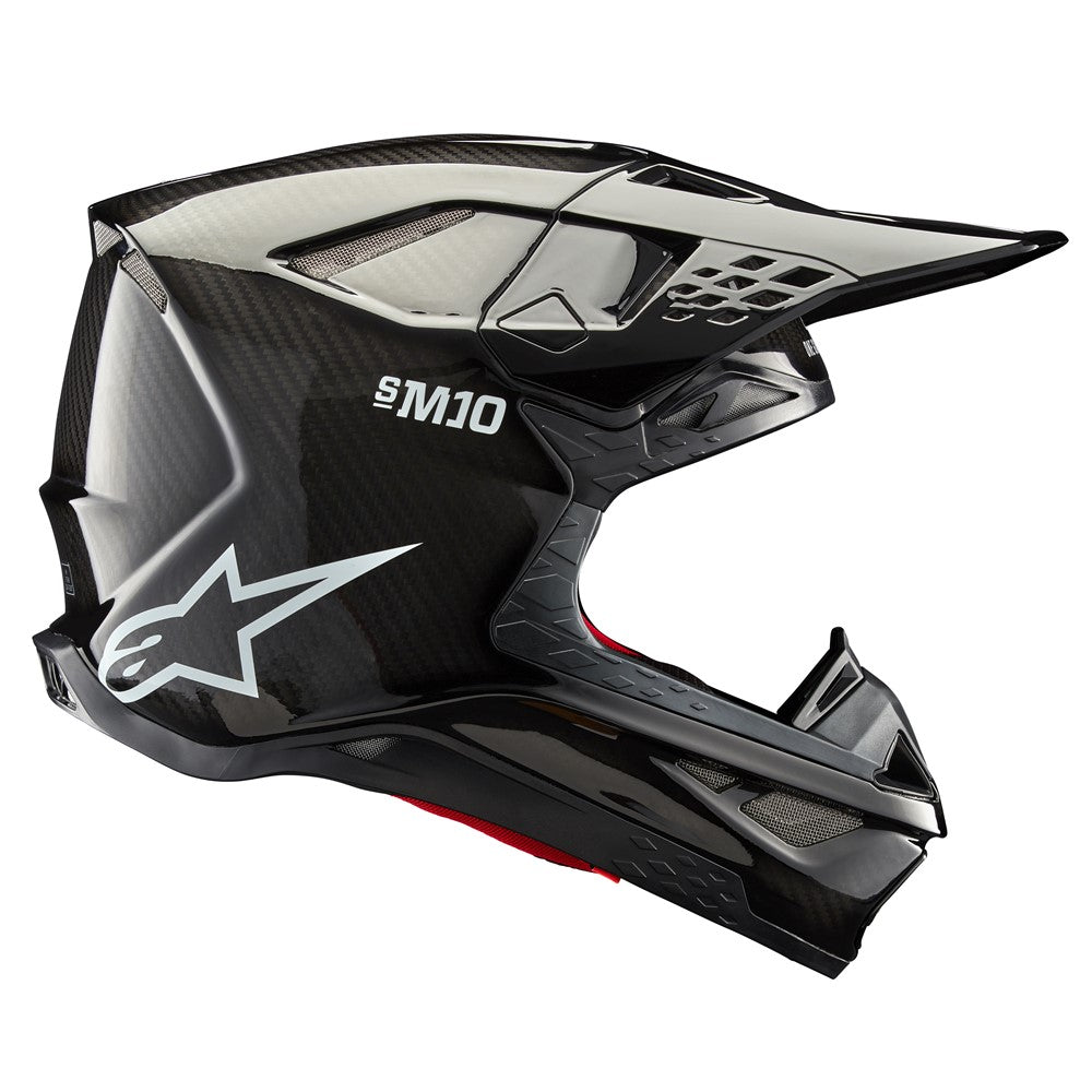 The ALPINESTARS Supertech S-M10 Helmet in Black Gloss Carbon features a sleek design with ventilation slits, an adjustable visor, and a white 