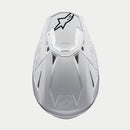 The ALPINESTARS Supertech S-M10 Solid White is a sleek, aerodynamic full-face motocross helmet with ventilation openings and angular contours. A black logo on the side enhances its modern style against a light gray background.