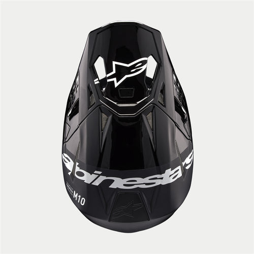 The Supertech S-M10 Helmet Flood Black/Dark Gray by Crown Kiwi Enterprises Limited features a sleek design with a glossy black finish and dark gray accents. Its aerodynamic profile is characterized by angular lines, a protective visor, and strategically placed vents for optimal ventilation.