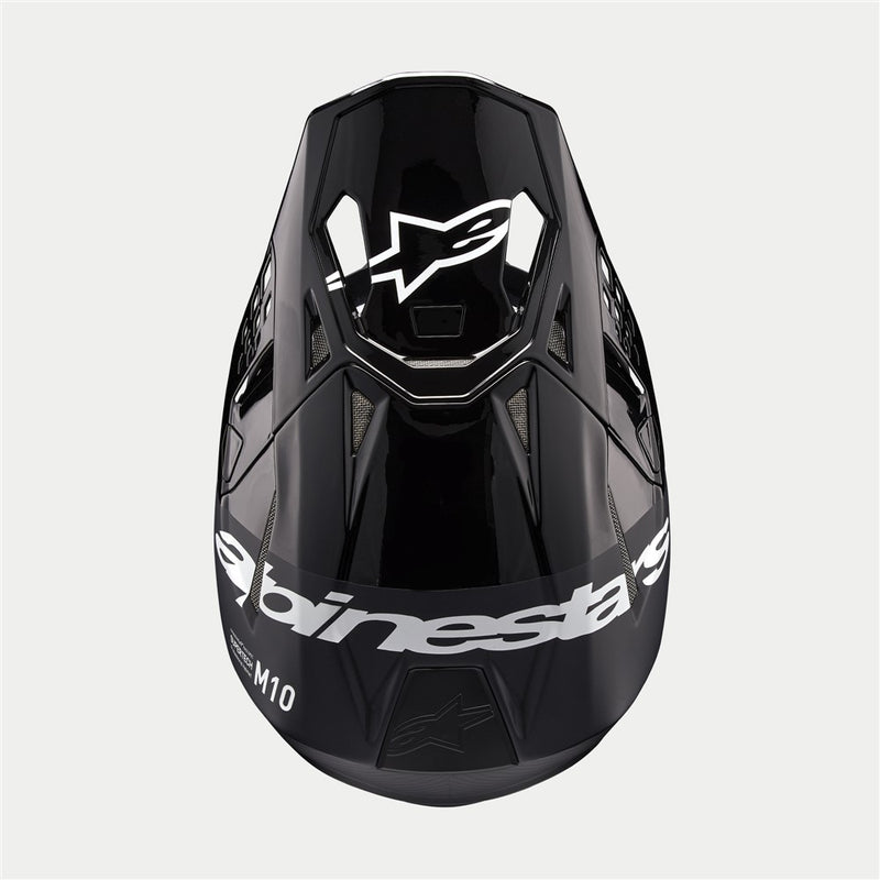 The Supertech S-M10 Helmet Flood Black/Dark Gray by Crown Kiwi Enterprises Limited features a sleek design with a glossy black finish and dark gray accents. Its aerodynamic profile is characterized by angular lines, a protective visor, and strategically placed vents for optimal ventilation.