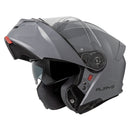 The RJAYS TOURTECH V Helmet in Solid Gloss Grey is a sleek, full-face motorcycle helmet featuring a flip-up front visor. Its aerodynamic shell includes an internal sun visor, a red button for visor release, and a cushioned interior lining. The brand name "RJAYS" is prominently displayed on the side.