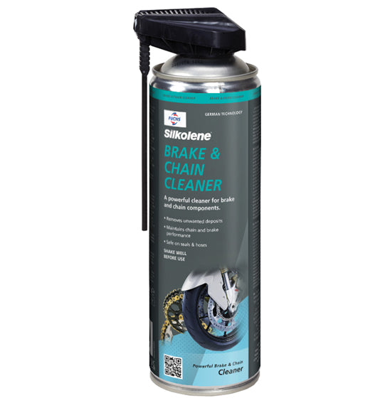 A can of Silkolene BRAKE & CHAIN CLEANER features a black nozzle and a blue-green label with a motorcycle wheel and chain image, highlighting its function in improving chain performance by cleaning brake and chain components.