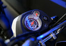 The Honda NAVi NVA110, by Honda, is a vibrant red mini motorcycle that emphasizes urban mobility with its compact design. It features a sleek black seat and the iconic Honda logo prominently displayed on its fuel tank. Equipped with thick black wheels and a short exhaust, this model expertly combines elements of a scooter and motorcycle to create an efficient ride ideal for city streets.