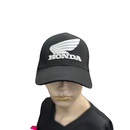 Showcasing the Honda Cap Black, branded by HRC, this cap displays a chic design from both front and back angles. The front prominently features the white Honda logo with stylized wings and "HONDA," set against a black background. Crafted from 100% cotton, the back of the cap includes an adjustable snapback strap, ensuring a perfect fit.