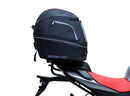 The image shows the EVO-12 Bike-Pack Kit by Ventura for Aprilia Tuono 660, RS660 (21 ->). It includes a black expandable bike pack, an Evo-Rack with Pannier Support, and a generic L-bracket and hardware. Each component is labeled: EVO-12 Pack, Adjustable Pack-Rack, and L-Bracket.