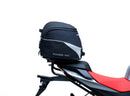 The image shows the EVO-12 Bike-Pack Kit by Ventura for Aprilia Tuono 660, RS660 (21 ->). It includes a black expandable bike pack, an Evo-Rack with Pannier Support, and a generic L-bracket and hardware. Each component is labeled: EVO-12 Pack, Adjustable Pack-Rack, and L-Bracket.