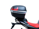 The image shows the EVO-12 Bike-Pack Kit by Ventura for Aprilia Tuono 660, RS660 (21 ->). It includes a black expandable bike pack, an Evo-Rack with Pannier Support, and a generic L-bracket and hardware. Each component is labeled: EVO-12 Pack, Adjustable Pack-Rack, and L-Bracket.