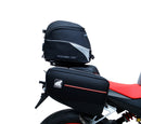 The image shows the EVO-12 Bike-Pack Kit by Ventura for Aprilia Tuono 660, RS660 (21 ->). It includes a black expandable bike pack, an Evo-Rack with Pannier Support, and a generic L-bracket and hardware. Each component is labeled: EVO-12 Pack, Adjustable Pack-Rack, and L-Bracket.