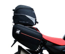 The image of the EVO-12 Bike-Pack Kit reveals three stylish components for the Aprilia Tuono V4 Factory (21 ->): a black pack with red accents, an EVO-Rack metal rack perfect for top-boxes, and versatile L-Brackets with screws. They’re ideal for customizing your adjustable Ventura pack-rack setup.