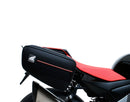The image of the EVO-12 Bike-Pack Kit reveals three stylish components for the Aprilia Tuono V4 Factory (21 ->): a black pack with red accents, an EVO-Rack metal rack perfect for top-boxes, and versatile L-Brackets with screws. They’re ideal for customizing your adjustable Ventura pack-rack setup.