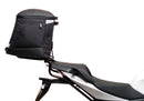 Ventura Aprilia Tuono V4 1100 (21 - >) Bike-Pack Kit shown with labeled images: EVO-12 Pack (soft black bag), EVO-Rack Top-Box Rack (metal bike-mounted rack), and generic L-Bracket plus mounting hardware.