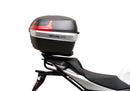 Ventura Aprilia Tuono V4 1100 (21 - >) Bike-Pack Kit shown with labeled images: EVO-12 Pack (soft black bag), EVO-Rack Top-Box Rack (metal bike-mounted rack), and generic L-Bracket plus mounting hardware.