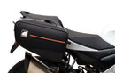 Ventura Aprilia Tuono V4 1100 (21 - >) Bike-Pack Kit shown with labeled images: EVO-12 Pack (soft black bag), EVO-Rack Top-Box Rack (metal bike-mounted rack), and generic L-Bracket plus mounting hardware.
