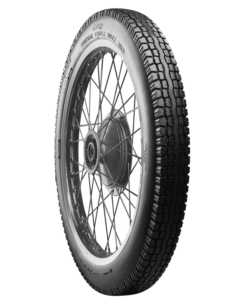 A black Avon Vintage and Classic Tire by Avon Tyres with a shiny silver rim shows a classic tread of thin parallel grooves on its circumference, set against a plain white background.