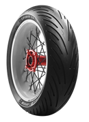 A black motorcycle tire with metal spokes and a shiny red hub is displayed against a black background. The tire is labeled "Avon Spirit ST" by Avon Tyres.