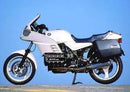 Image showing the Ventura EVO-12 Bike-Pack Kit for BMW K 100 RS-16V (90-93), featuring a black EVO-12 Pack, an Evo-Rack Top-Box Rack, and a black L-Bracket with hardware.