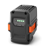 The Husqvarna B140 Battery features a black and orange rugged case, indicator lights with four green bars for full charge status, and supports fast charging—ideal for outdoor power equipment.