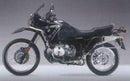 Image featuring three parts of the Ventura EVO-12 Bike-Pack Kit: the black EVO-12 Pack, the sleek black metal Evo-Rack for BMW R 100 GS (1992), and a set of L-Brackets with screws.
