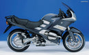 The EVO-12 Bike-Pack Kit for BMW K 1200 R (05-08) with Factory Rear Carrier by Ventura includes a black bike-pack, metal Top-Box Rack, and L-Bracket set with screws. Each item is clearly labeled for easy identification.
