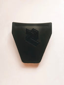 Close-up of the Rabaconda Bead Break Cover for Street Bike Tyre Changer by Rabaconda, featuring a sleek black plastic design with angular lines and a raised geometric pattern on a white background. Its surface is smooth and reflective.