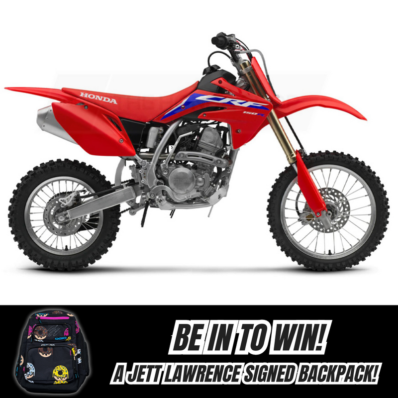 Image of a red 2025 Honda CRF150RB with a silver frame and black wheels. Below, text reads, "BE IN TO WIN! A Jett Lawrence signed backpack!" A black, logo-adorned backpack with signatures is shown beside the text. Explore finance options today!.