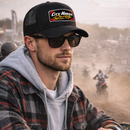 Man wearing a City Honda Racing cap and sunglasses at a motocross event.