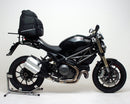 The EVO-12 Bike-Pack Kit image highlights a sleek Ventura bike pack labeled "EVO-12 Pack," including an "Adjustable Pack-Rack" mounted on a Ducati 1100 Monster Diesel (2013) and secured with sturdy black L-Brackets and screws, promising stylish and secure biking adventures.
