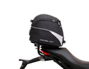 The Ducati 821 Monster (17-21) kit by Ventura showcases a stylish black bike pack with a red stripe and "EVO-12 PACK" label, plus the versatile "EVO-RACK" top-box rack. It includes sturdy L-BRACKET mounts with screws and fittings for secure attachment.