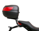 The Ducati 821 Monster (17-21) kit by Ventura showcases a stylish black bike pack with a red stripe and "EVO-12 PACK" label, plus the versatile "EVO-RACK" top-box rack. It includes sturdy L-BRACKET mounts with screws and fittings for secure attachment.