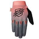 The FIST DUSK GLOVE is a single motocross glove with a pink cuff, gradient fade to gray fingers, "FIST" on the knuckles, and a bold raised fist graphic on the back of the hand.