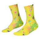 A pair of AEROBIX FLUORO YELLOW SOCKS with various colorful patterns, including pink and green geometric shapes, checkerboard designs, and zigzag lines. Crafted from super soft cotton, they feature targeted arch compression for added support and the brand name "FIST" near the top. The toes are solid yellow.