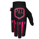The FIST FLURO PINK STOCKER GLOVE is a black motocross glove with pink accents, "FIST" lettering on the fingers, a fist logo on the back, and a small "FIST" wrist tag.