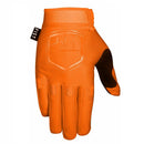The FIST ORANGE STOCKER GLOVE features "FIST" embossed on the fingers, a fist logo on the back, and a black "FIST" tag near the wrist—ideal motocross gloves for riders who value both style and grip.