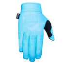 The FIST SKY STOCKER GLOVE is light blue with a black thumb patch, "FIST" across the fingers, a fist emblem on the back, and a small black tag with "FIST" near the wrist.