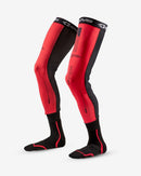 The FUSION SOCK / SLEEVE COMBO | 40TH ANNIVERSARY by EVS Sports is a pair of black and red compression leg sleeves with socks attached, featuring Trac Grip technology. Branding and design details in black appear on the red sections.