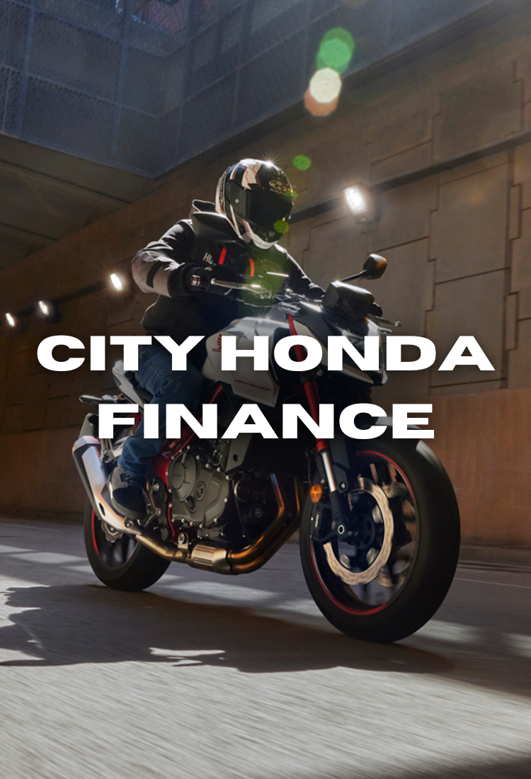 A motorcyclist wearing gear rides a motorcycle through an urban tunnel. The text "City Honda Finance" overlays the image, promoting the brand.