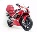 Image shows a Ventura EVO-12 Bike-Pack Kit for Honda VTR 1000 SP-1 (2000), featuring a black bike-pack with an orange stripe, Adjustable Pack-Rack, L-bracket set with screws, and clear labels for easy identification.