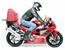 Image shows a Ventura EVO-12 Bike-Pack Kit for Honda VTR 1000 SP-1 (2000), featuring a black bike-pack with an orange stripe, Adjustable Pack-Rack, L-bracket set with screws, and clear labels for easy identification.