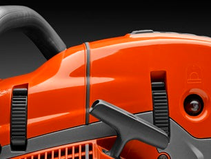 A Husqvarna 572 XP-24® Chainsaw with an orange body and a long metal cutting bar is perfect for all your outdoor needs. Shown from the side, it proudly displays the "Husqvarna" brand on the bar, along with intricate details of the engine and handle.