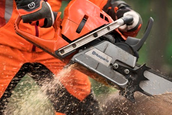 A Husqvarna 572 XP-20® Chainsaw featuring an orange body, a long metal blade, and the brand's logo on the blade. The handle and motor are visible, with the power to tackle heavy-duty cutting tasks in gardens and other outdoor settings.