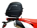 Image displaying components of the EVO-12 Bike-Pack Kit, featuring a black pack with an orange Ventura logo (top left), an EVO-Rack mounted on a bike with pannier support (top right), and a generic L-bracket with screws (bottom). Product for Honda CRF 450 L (2019).