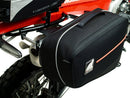 Image displaying components of the EVO-12 Bike-Pack Kit, featuring a black pack with an orange Ventura logo (top left), an EVO-Rack mounted on a bike with pannier support (top right), and a generic L-bracket with screws (bottom). Product for Honda CRF 450 L (2019).