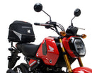 The image showcases a Ventura Honda MSX 125 Grom (21 - >) Bike-Pack Kit with three components: a sleek black EVO-12 Pack with a small logo, an EVO-Rack for mounting, and an L-Bracket with screws. It's perfect for riders seeking versatile storage solutions.