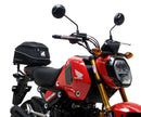 The image showcases a Ventura Honda MSX 125 Grom (21 - >) Bike-Pack Kit with three components: a sleek black EVO-12 Pack with a small logo, an EVO-Rack for mounting, and an L-Bracket with screws. It's perfect for riders seeking versatile storage solutions.