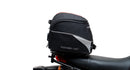 The image showcases a Ventura Honda MSX 125 Grom (21 - >) Bike-Pack Kit with three components: a sleek black EVO-12 Pack with a small logo, an EVO-Rack for mounting, and an L-Bracket with screws. It's perfect for riders seeking versatile storage solutions.